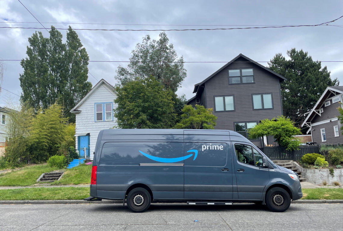 An Amazon cargo van parked on a residential street.